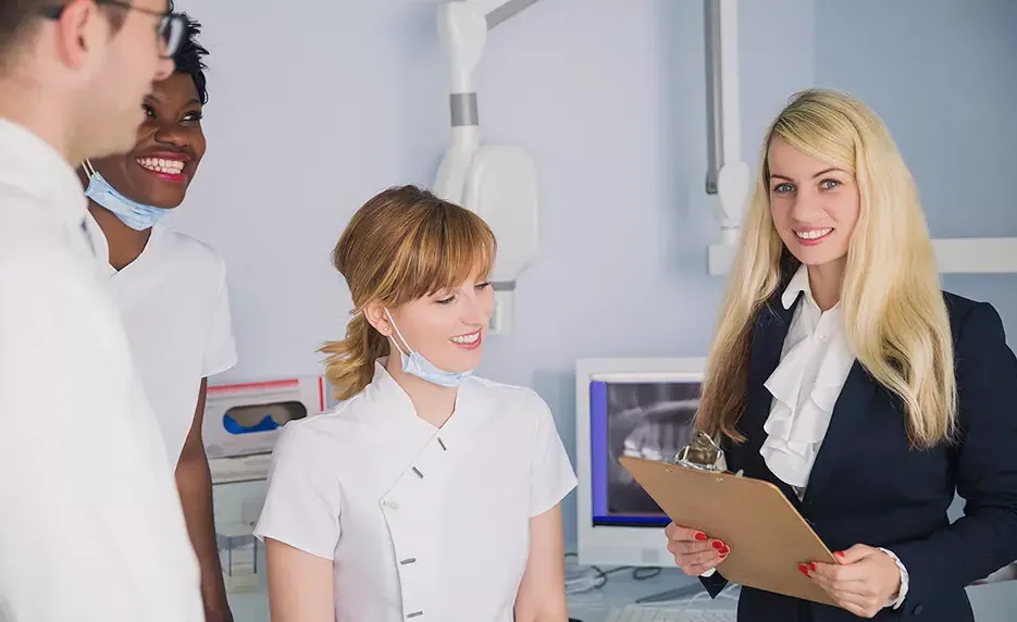 Dental office manager consults with the doctor and nurses